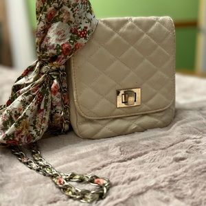 Really sweet Aldo crossbody bag with floral accessory.